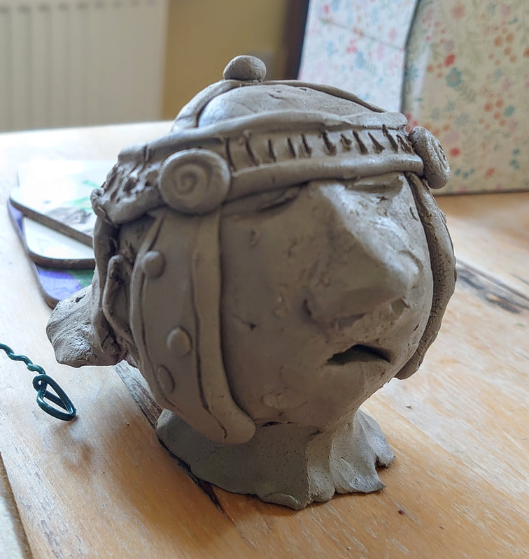 clay roman head