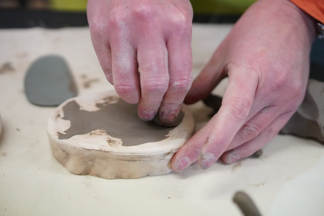 hands moulding clay 
